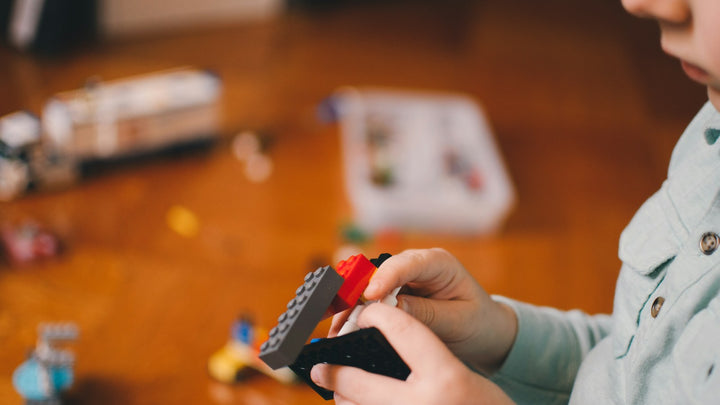 A child building with colorful toy blocks