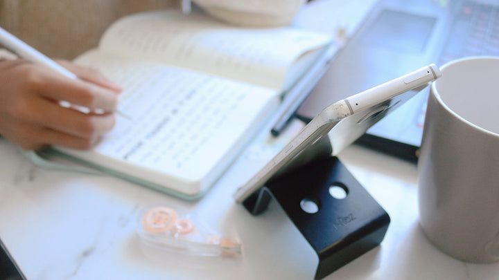 Writing notes in a notebook at a desk
